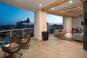 a large terrace with a view of the city at night